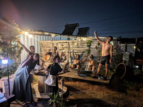 a group of people standing in front of a house at あさひシーサイドコテージ in Asahi