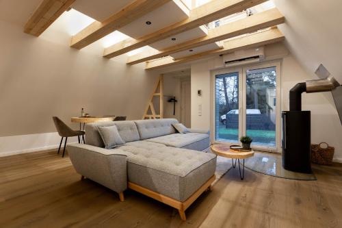 a living room with a couch and a table at Nurdachhaus Winsen Aller in Winsen Aller