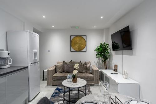 a living room with a couch and a table at Avalon luxury stays in Strood