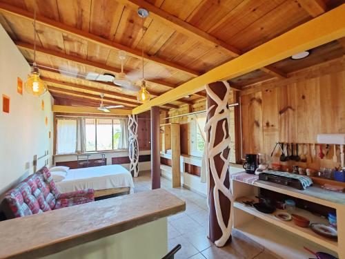 a kitchen and living room with wooden walls and ceilings at Casa Gio Paraiso Escondido in Puerto Escondido