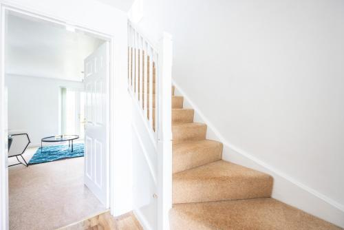 a staircase in a home with white walls at PrimeStay Residence in Slough