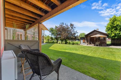 a patio with two chairs and a yard at Mt Gardner Inn in Winthrop