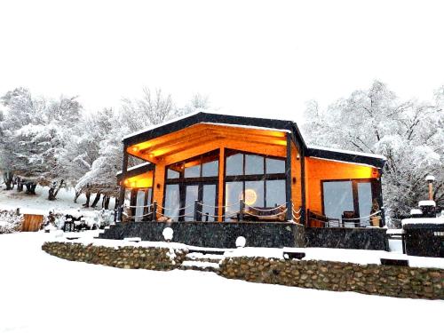 a cabin in the snow with snow covered trees at Balada dintre dealuri - Casa Soarelui si Casa Lunii in Cisnadioara