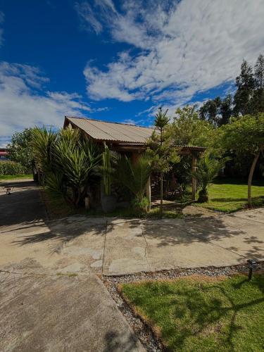 a small house with a roof on a street at Hotel El Rancho in Concepción