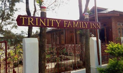 a sign that reads trinity family inn in front of a house at Trinity Family Inn in Nyaung Shwe