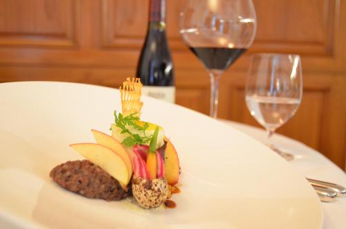 a plate of food on a table with wine glasses at Bad Schauenburg in Liestal