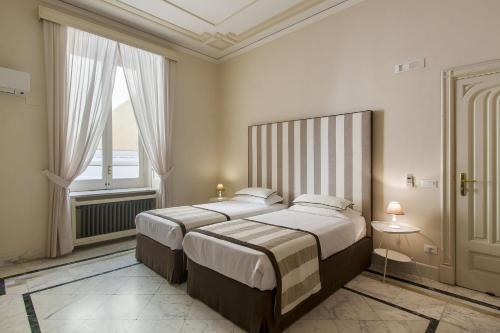 En eller flere senge i et værelse på Palazzo Starace