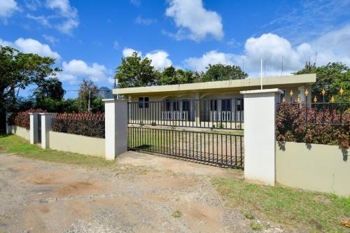 a white fence in front of a house at Chic Getaway 1 in Choiseul