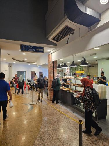 a group of people standing around a kitchen in a restaurant at NEW Bangsar Trade Centre KL Mid Valley LRT Bangsar in Kuala Lumpur