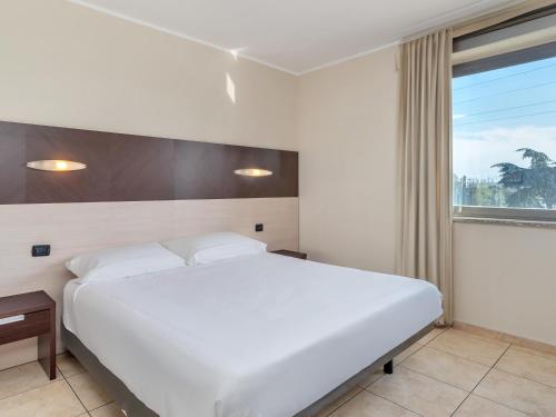 Postel nebo postele na pokoji v ubytování B&B HOTEL Settimo Torinese
