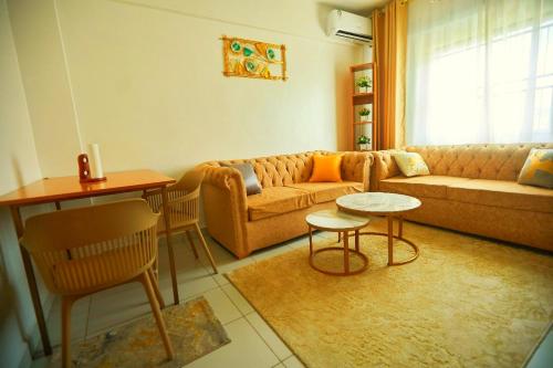 a living room with a couch and a table at Shanzu Oceanfront Apartments and Suites in Mombasa