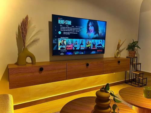 a living room with a flat screen tv on a entertainment center at sea view apartment in Tangier