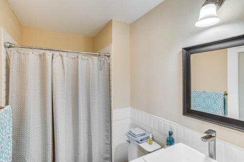 a bathroom with a shower curtain and a toilet at 4 Mi to Train Station Central San Bernardino Home in San Bernardino