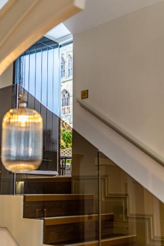 a staircase with a large window and a pendant light at St Marys Quarters in Nottingham