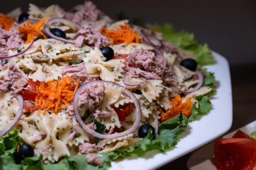 a plate of food with a salad on a table at HOTEL ASTRAL in Abidjan