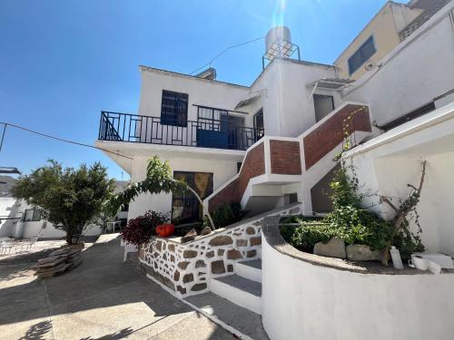 a white building with stairs and a balcony at Casa Angelitos in Guanajuato