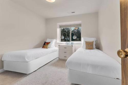 a white bedroom with two beds and a window at Lake Tahoe Getaway Close to Beach & Ski Slopes in Tahoe City
