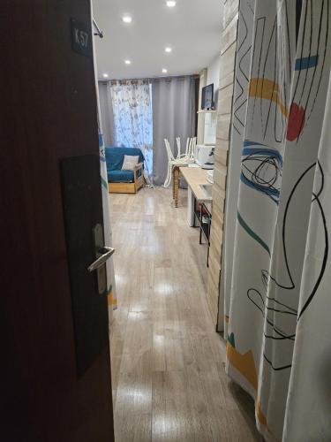 une pièce avec un couloir avec une table et une cuisine dans l'établissement Studio pied des pistes, à Villard-de-Lans