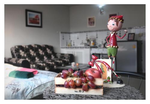 a table with a figurine on top of a table with fruit on it at Impact Arena C3 Milo in Nonthaburi