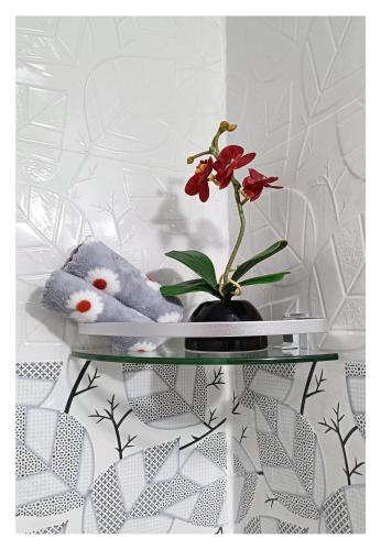 a teddy bear and a flower on a glass table at Impact Arena C3 Milo in Nonthaburi