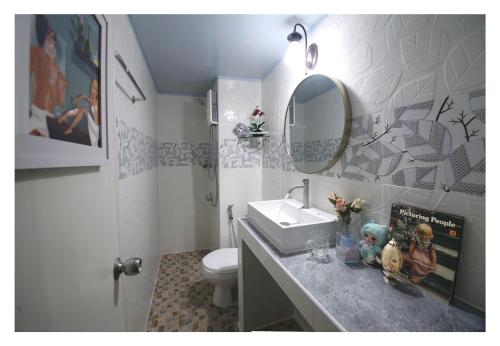 a bathroom with a sink and a toilet and a mirror at Impact Arena C3 Milo in Nonthaburi