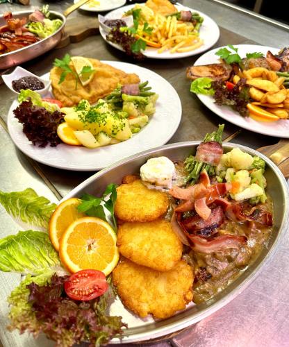 a table full of plates of food on a table at Hotel Marienhof in Fliess