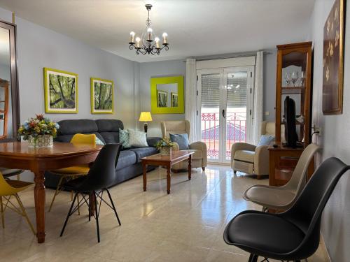 a living room with a couch and a table at Apartamentos Turisticos Juanita "Ope" in Archena
