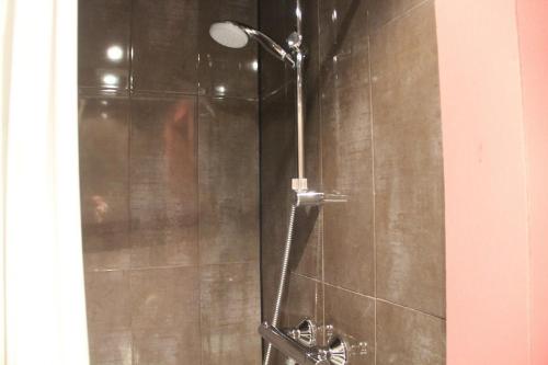 a shower with a shower head in a bathroom at THE82 HOSTEL Midi in Brussels