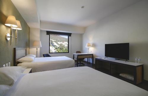 Postel nebo postele na pokoji v ubytování Hotel Turotel Morelia