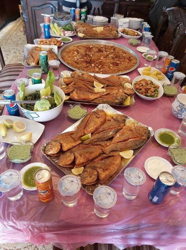 a table with many different types of food on it at Zarmot INN in Az Zarqa