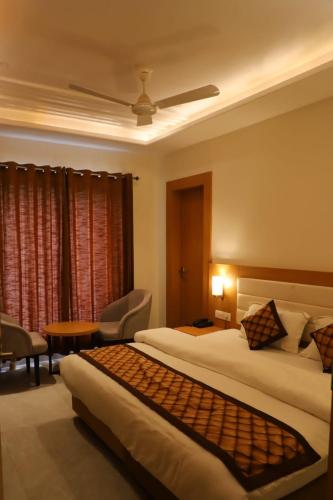 a hotel room with two beds and a table at Ananda Castle in Vrindāvan