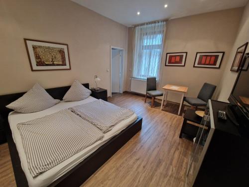 a bedroom with a bed and a table and chairs at Weingut Haxel in Cochem