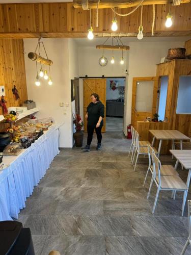 a man standing in the middle of a room at Patriko Mountain Chalet in Palaios Agios Athanasios