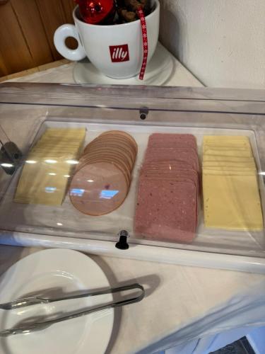 a plastic tray with different types of food in a refrigerator at Patriko Mountain Chalet in Palaios Agios Athanasios