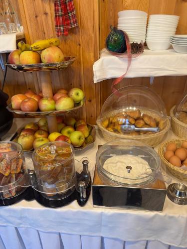a table filled with lots of different types of food at Patriko Mountain Chalet in Palaios Agios Athanasios