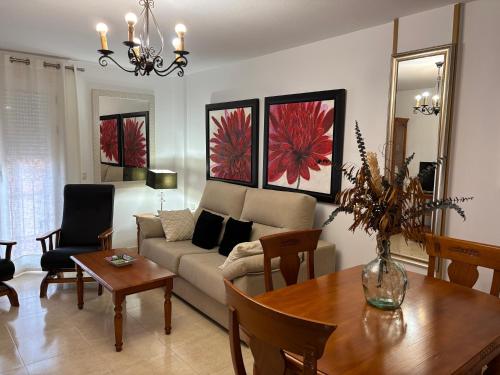 a living room with a couch and a table at Apartamentos Turisticos Juanita "Ope" in Archena