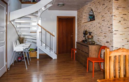 a room with a staircase and a table and chairs at Stunning Home In Hammenhög With Sauna in Hammenhög