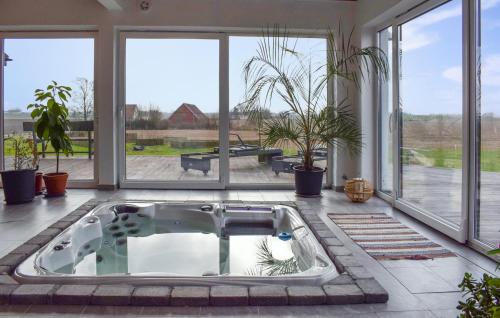 a hot tub in a room with large windows at Stunning Home In Hammenhög With Sauna in Hammenhög
