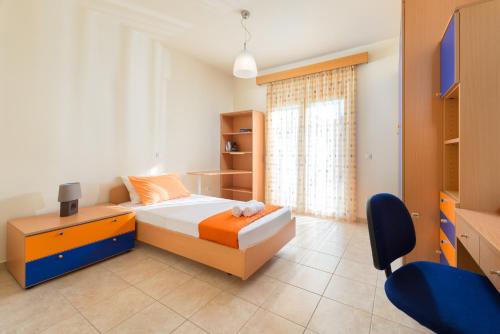 a bedroom with a bed and a desk and a tv at villa de calme in Pastida