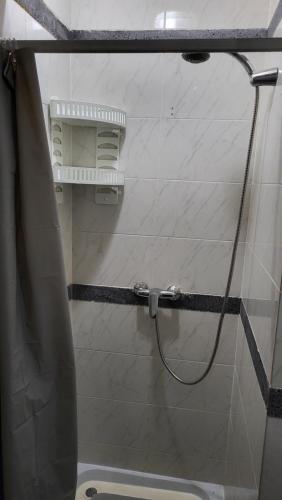 a shower with a shower curtain in a bathroom at The Blue Hydrangea in Vila Franca do Campo