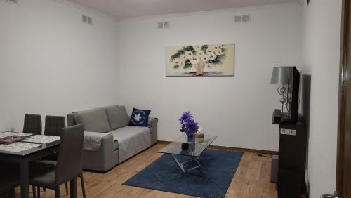 a living room with a couch and a table at The Blue Hydrangea in Vila Franca do Campo