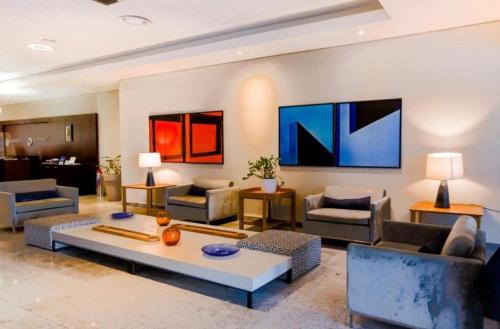 a living room with couches and a table at Beach Class International - Beira Mar - Boa Viagem in Recife