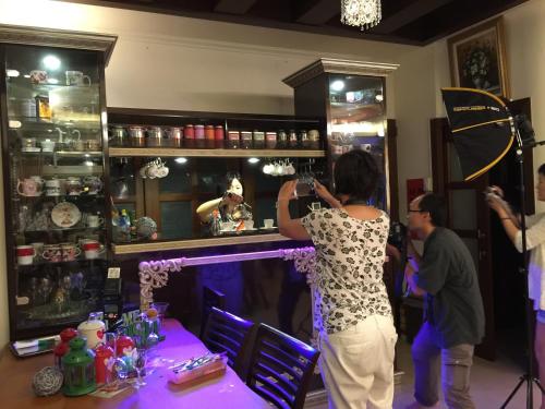 a woman taking a picture in a barber shop at Mandy's House B&B in Shangwu