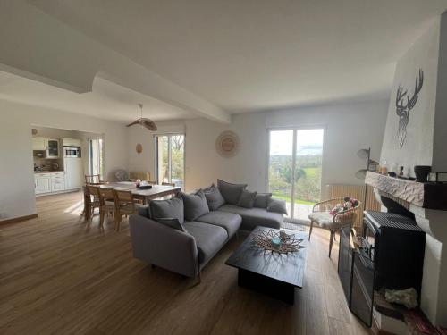 un salon avec un canapé et une table dans l'établissement Maison entre mer et campagne, à Douville-en-Auge