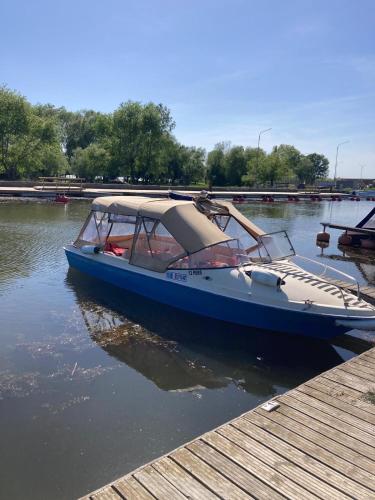 a blue boat is docked at a dock at Casa Soarelui in Murighiol