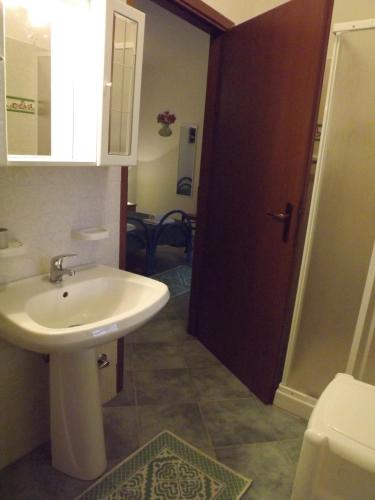 a bathroom with a white sink and a toilet at Agriturismo Quattro Mori in Porto Torres