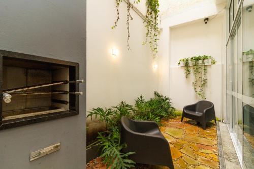 a room with two chairs and a fireplace at 360 Sanfran Riachuelo in Sao Paulo