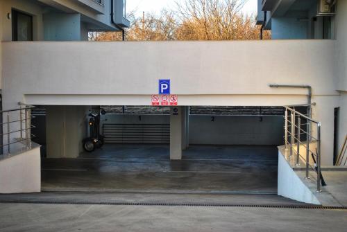 a parking garage with a parking sign on the side of a building at Studio near Airport & Therme Wellness SPA in Otopeni