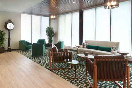 a lobby with a couch and chairs and a clock at Fairfield by Marriott Inn & Suites Grovetown in Grovetown