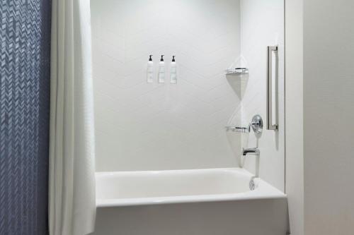 a bathroom with a white tub and a shower at Fairfield by Marriott Inn & Suites Grovetown in Grovetown